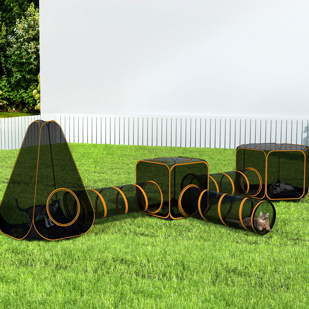 Folding six-in-one pet playpen with tunnel and mesh panels set up on grass
