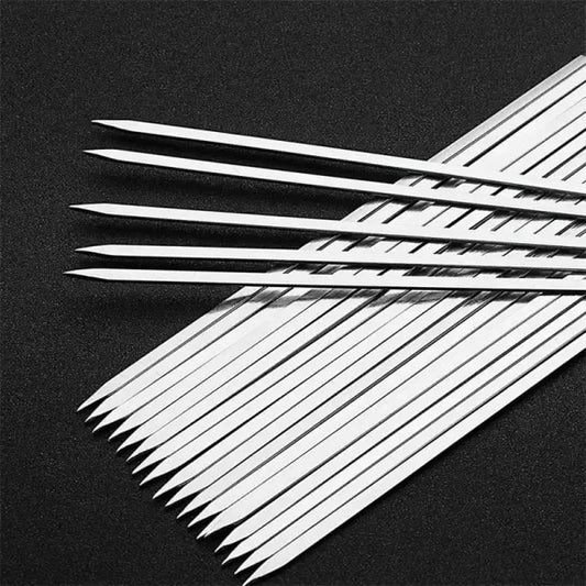 Ten flat-bladed stainless steel barbecue skewers laid out in a row