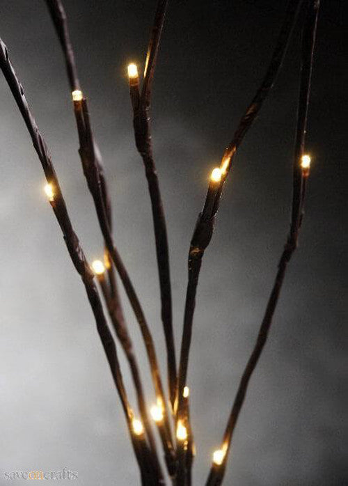 LED branch stems with warm white bulbs arranged as a table centrepiece