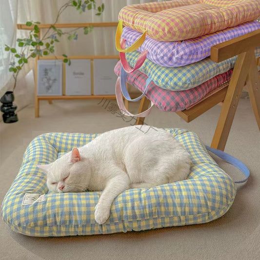 Large washable all-season pet bed in yellow and purple on a timber floor