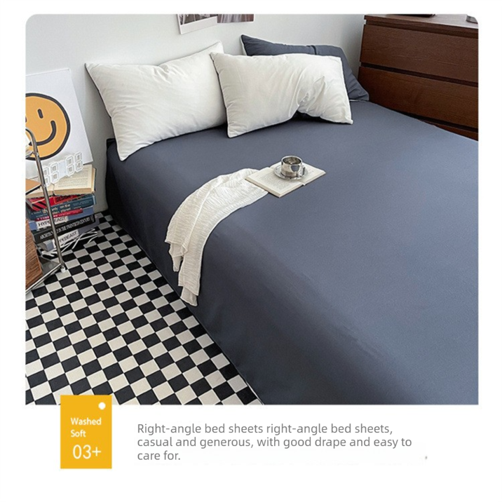 Washed cotton bedding set in light green and camel made up on a bed
