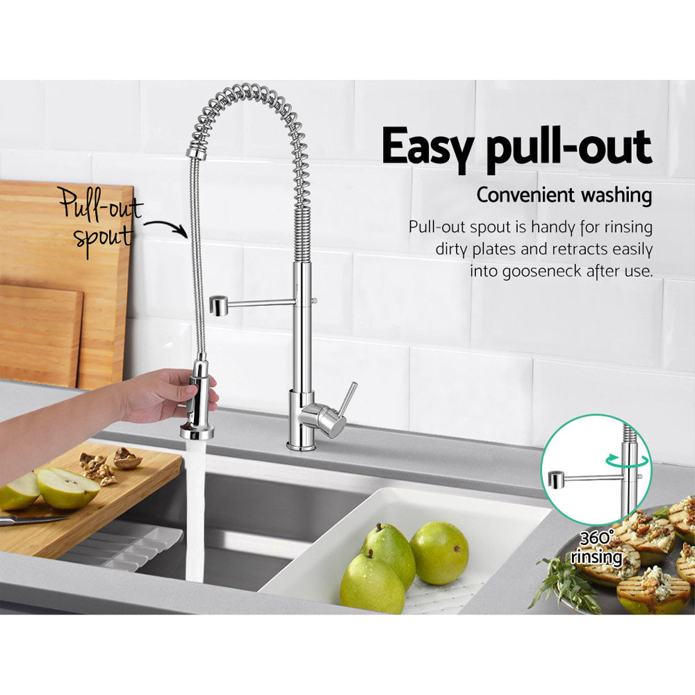 Polished chrome pull-down kitchen mixer tap over a stainless sink