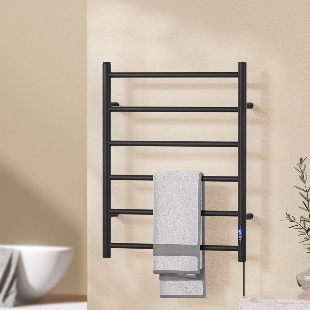Black six bar wall mounted heated towel rail with towels hanging
