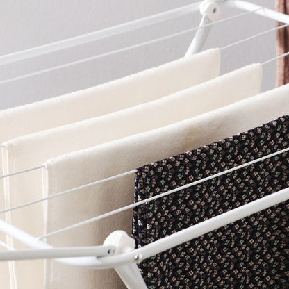 White folding clothes drying rack with double-wing sides and horizontal bars