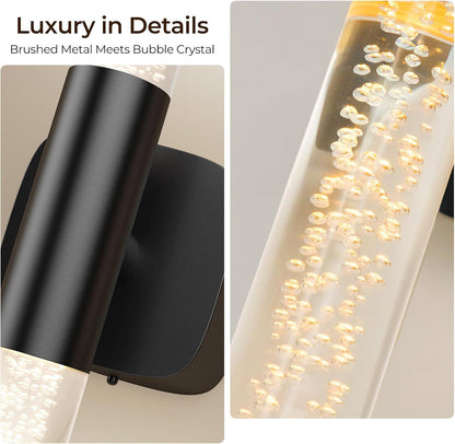 Pair of gold and crystal battery wall sconces lit on a bedroom wall