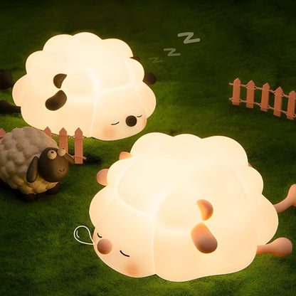 Soft rubber sheep night light glowing warm white on a bedside surface