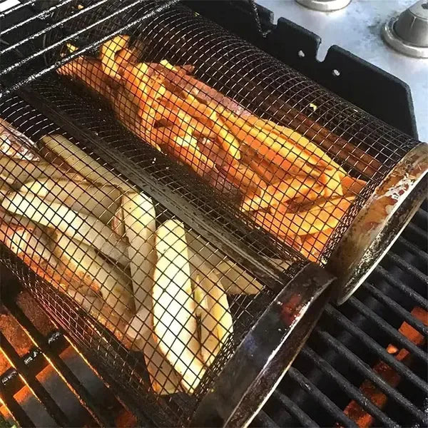 Cylindrical stainless steel mesh grill basket filled with vegetables on a barbecue