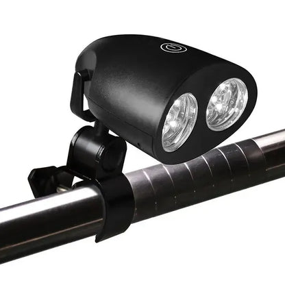 Black clip-on LED grill light clamped to a barbecue handle at night