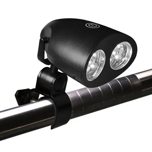 Black clip-on LED grill light clamped to a barbecue handle at night