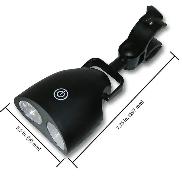 Black clip-on LED grill light clamped to a barbecue handle at night