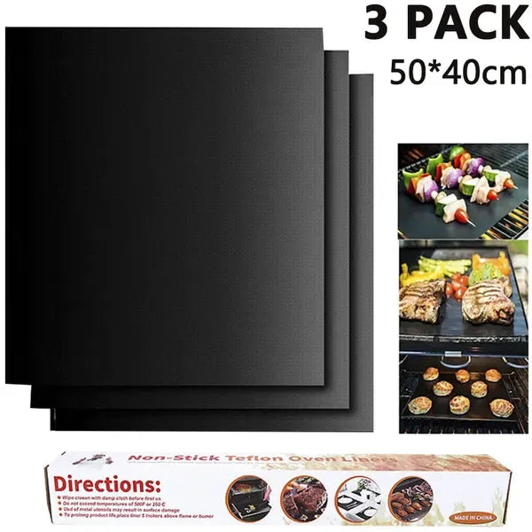 Three black non-stick barbecue grill mats with food cooking on one