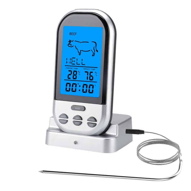 Wireless meat thermometer with LCD display and two probes beside a barbecue
