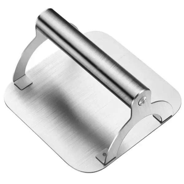 Square stainless steel burger press with round handle on a hot flat top