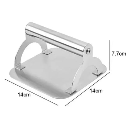 Square stainless steel burger press with round handle on a hot flat top
