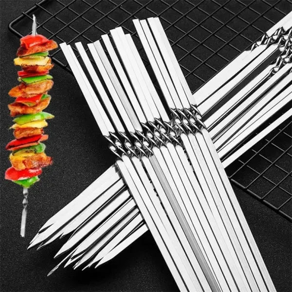 Ten flat-bladed stainless steel barbecue skewers laid out in a row