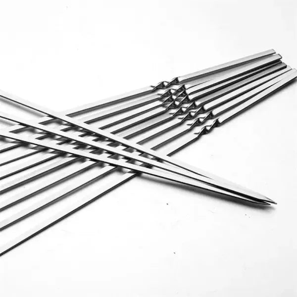 Ten flat-bladed stainless steel barbecue skewers laid out in a row