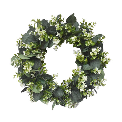 Artificial eucalyptus wreath with white berries hanging on a front door
