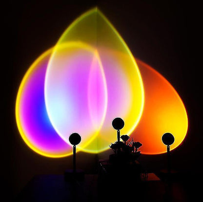 Rotating projection lamp casting a warm sunset glow across a bedroom wall