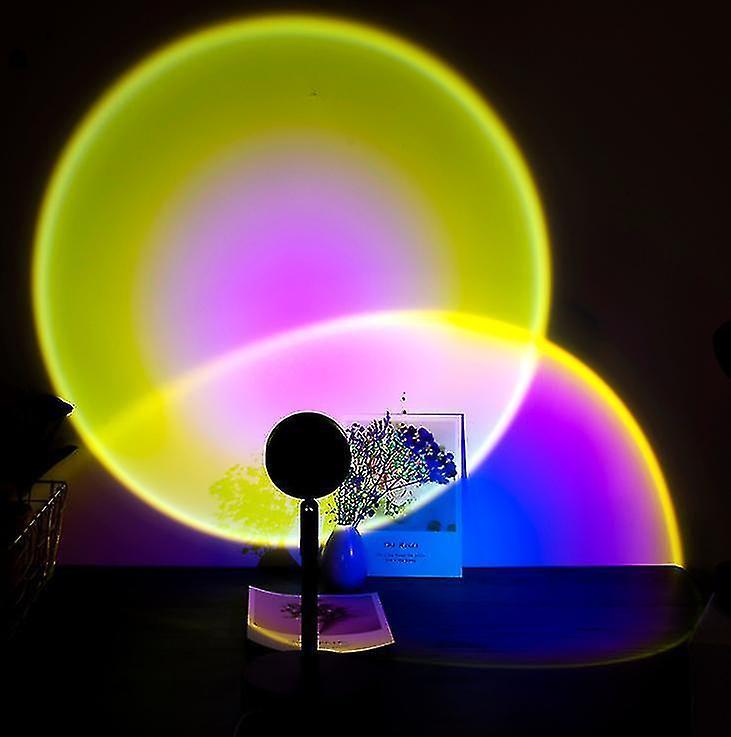 Rotating projection lamp casting a warm sunset glow across a bedroom wall