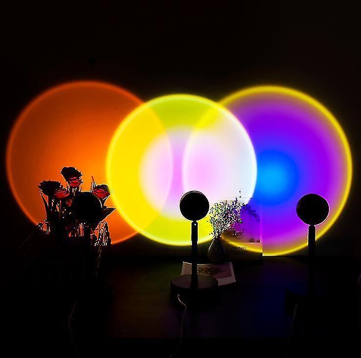 Rotating projection lamp casting a warm sunset glow across a bedroom wall