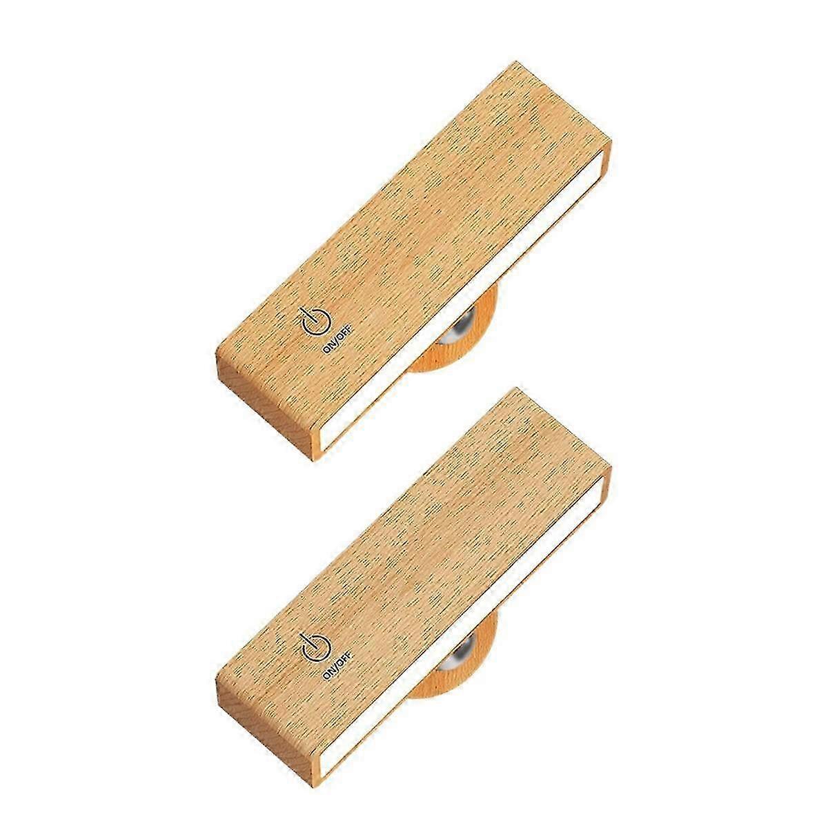 Pair of timber battery wall sconces mounted on a wall and lit warm white