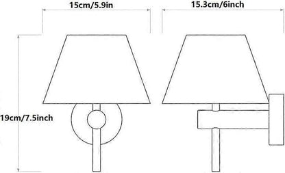 Pair of chrome wall sconces with white linen shades lit on a bedroom wall