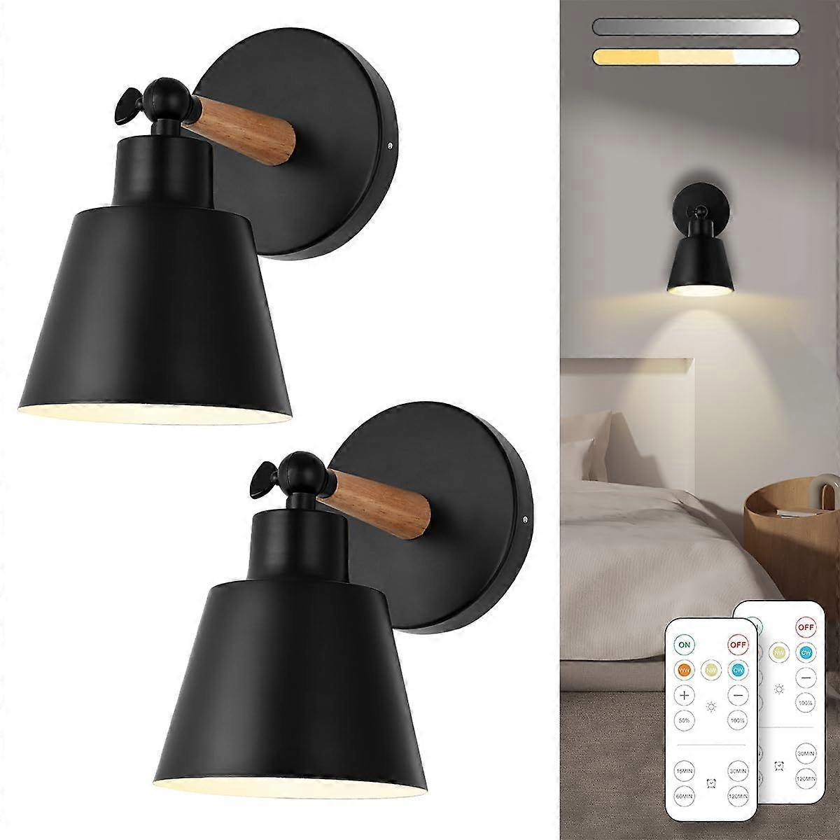 Pair of battery operated wall sconces lit on a wall with a remote control