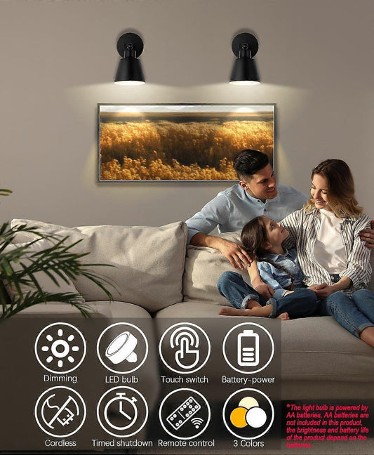 Pair of battery operated wall sconces lit on a wall with a remote control