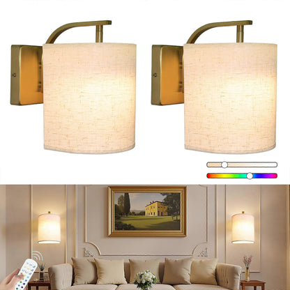 Pair of gold rechargeable wall sconces lit in colour on a wall
