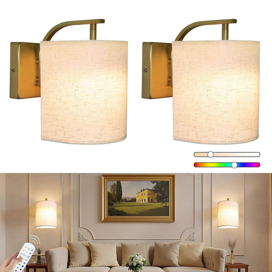 Pair of gold rechargeable wall sconces lit in colour on a wall