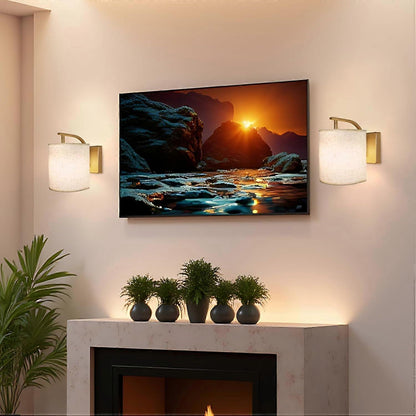 Pair of gold rechargeable wall sconces lit in colour on a wall