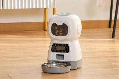 White automatic pet feeder with digital controls and food dispensing tray