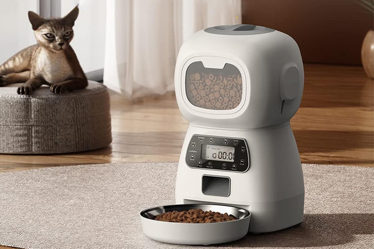 White automatic pet feeder with digital controls and food dispensing tray