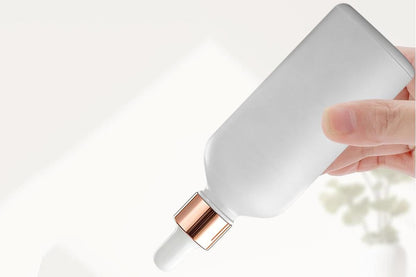Pack of 10 matte white glass dropper bottles with rose gold caps