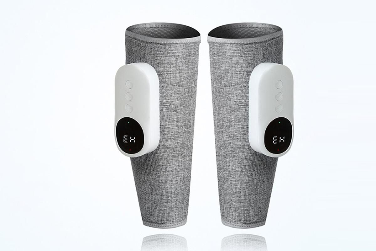 Grey heated leg massager with wraparound design and hook and loop closure