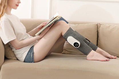 Grey heated leg massager with wraparound design and hook and loop closure