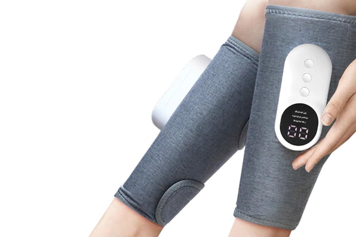 Grey heated leg massager with wraparound design and hook and loop closure