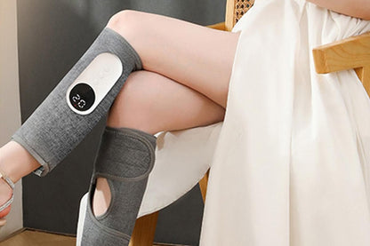 Grey heated leg massager with wraparound design and hook and loop closure
