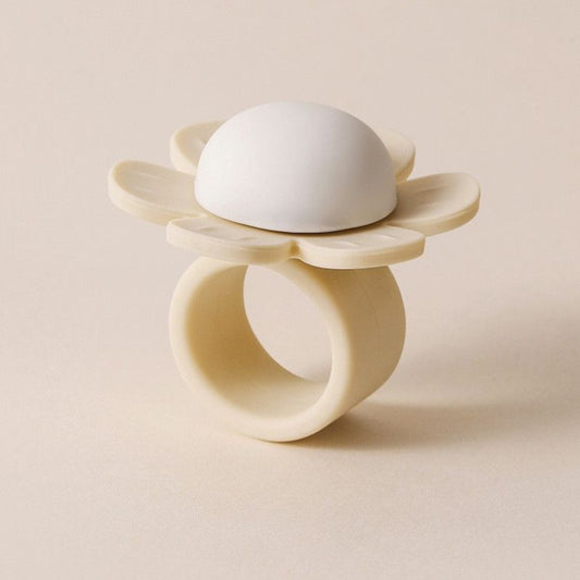 Beige sunflower-shaped silicone bumper fitted over a door handle