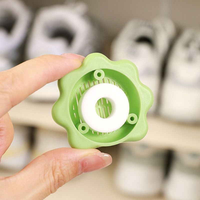 Grey sunflower-shaped deodoriser discs with adhesive backing