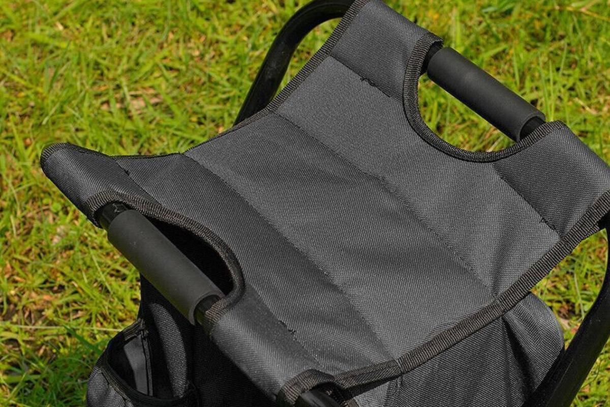 Black folding backpack cooler stool with seat, carry straps and storage compartment