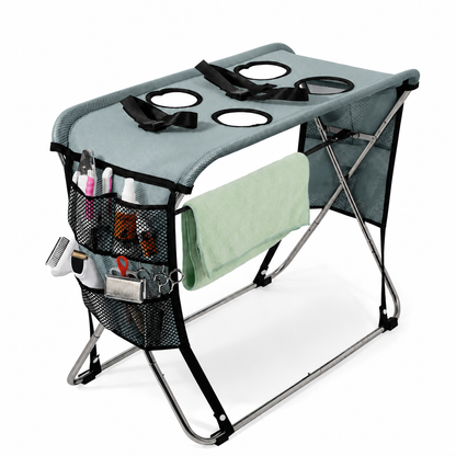 Pink foldable pet grooming table with mesh top, restraint strap and towel bar