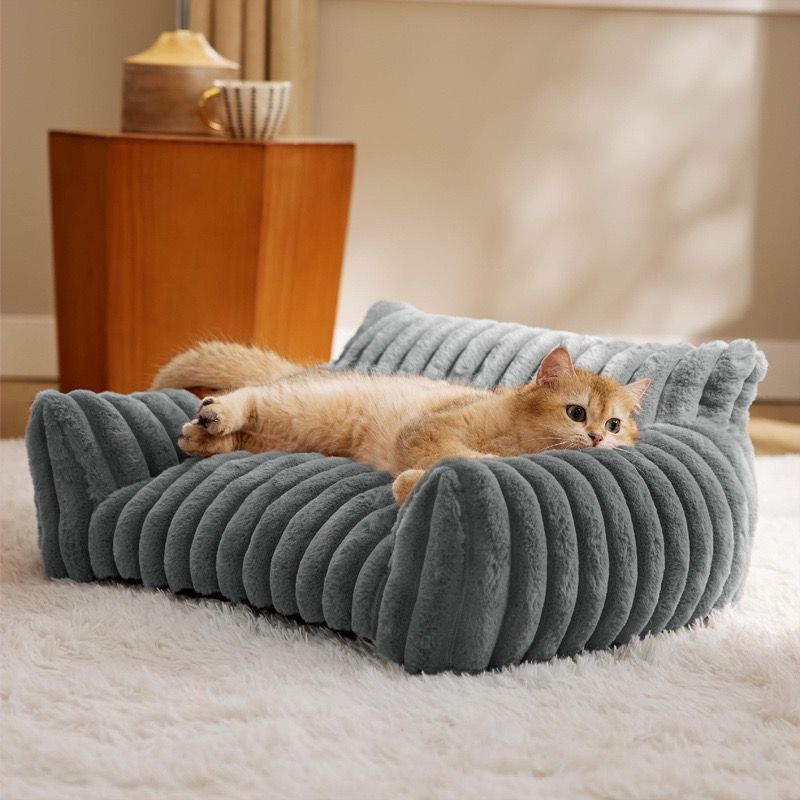 Brown faux fur pet sofa bed with raised bolster sides and deep cushion