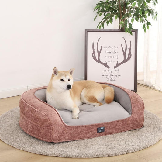 Pink orthopaedic pet sofa bed with bolstered edges and a removable cover