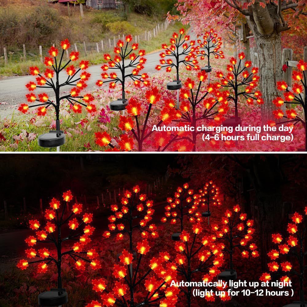 Three solar maple leaf stake lights glowing warm amber in a garden setting