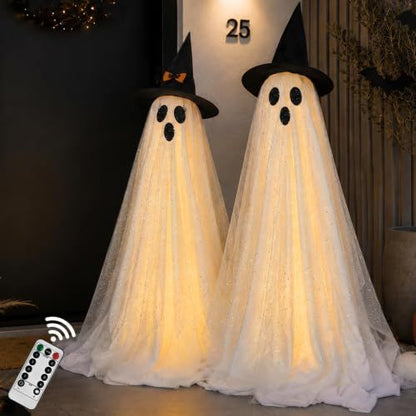 Tall standing white Halloween ghost decorations lit from within on a porch