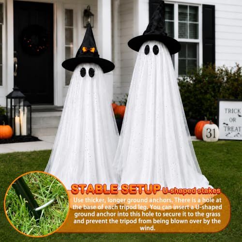 Tall standing white Halloween ghost decorations lit from within on a porch