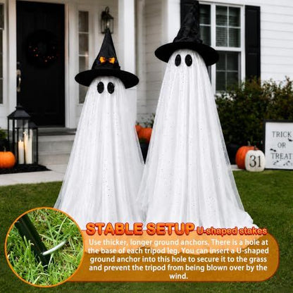 Tall standing white Halloween ghost decorations lit from within on a porch