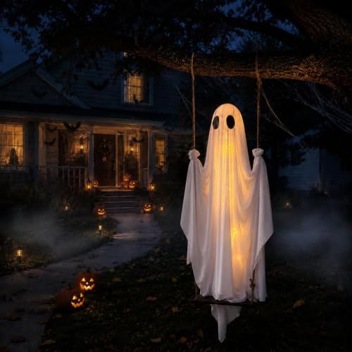 White fabric Halloween ghost hanging from a porch and lit from within