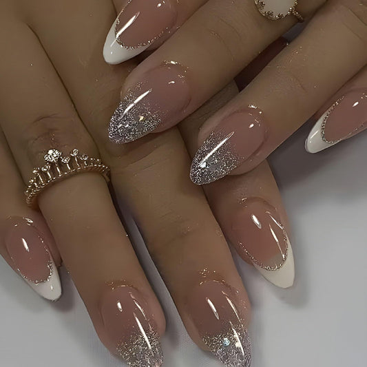 Set of nude pink press-on nails with glossy finish and glitter tip designs